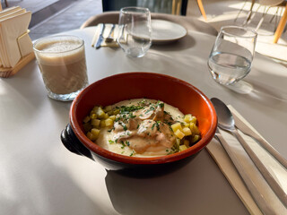 Mashed potatoes with meat and pickles in a ceramic bowl. Traditional Eastern Europe comfort food in rustic bowl. Concept of homemade lunch and hearty nourishment