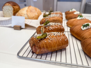 Artisan croissants with sesame and pickle. Modern fusion bakery and creative snack design