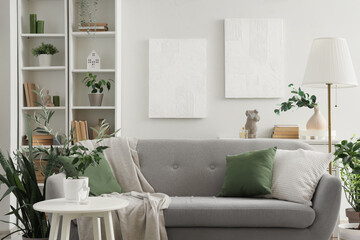 Sofa and houseplants in interior of living room