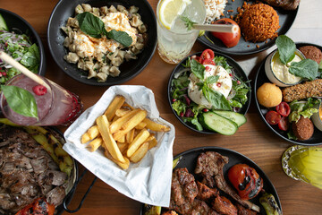 Mixed grill with salads and fries.
