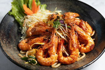 Noodles with shrimp on plate