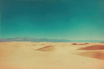 Vast desert landscape under a vibrant teal sky, featuring gently rolling sand dunes and distant mountains.