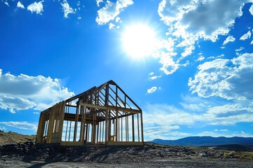 House under construction with wooden frame under blue sky