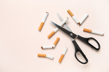 Scissors with cigarettes on color background. No Tobacco Day concept