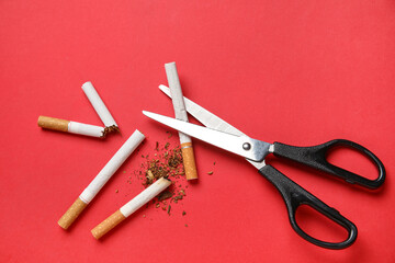 Scissors with cigarettes on red background on red background. No Tobacco Day concept