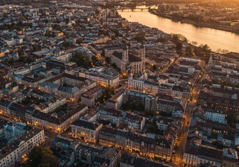 Aerial View of City at Sunset with Illuminated Buildings and River