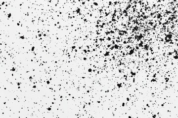 Obraz premium A close-up of a white surface speckled with black dots, creating a textured, grainy pattern