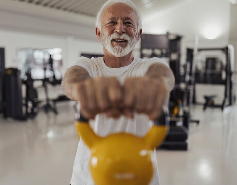 Older man using weights to get stronger