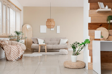 Interior of studio apartment with sofa, armchair and table