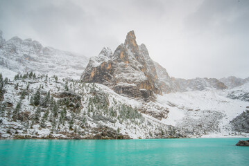 Lake Sorapis, Dolomites, Italy. Lake and reflections on the water surface. Mountain landscapes with turquoise water. Place for mountain hiking, travel and vacation. Wallpaper, postcard, photo.