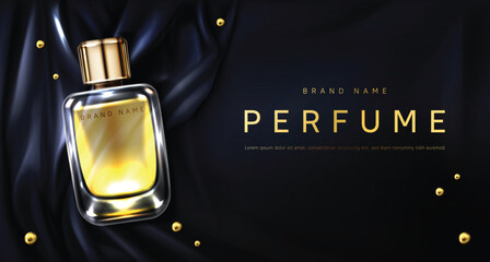 Perfume bottle on black silk fabric background