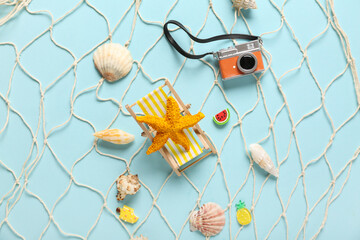 Net with different beach decor on blue background