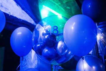 Celebration setup with blue balloons and lights