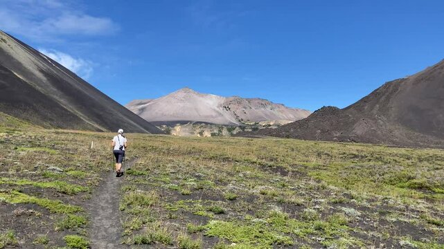 female hiker in the mountains ascending towards Achen Niyeu volcano at Lanin national park, patagonia, argentina, south america