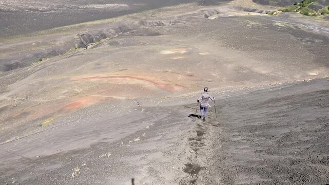 female hiker in the mountains descending from peak of Achen Niyeu volcano at Lanin national park, patagonia, argentina, south america