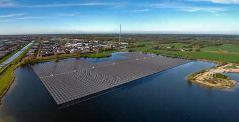 Aerial view of large-scale floating photovoltaic system installed on a reservoir adjacent to...