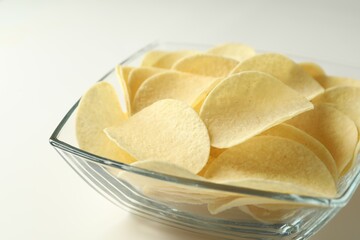 Tasty potato chips on white background, closeup