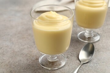 Tasty vanilla pudding served on grey table, closeup