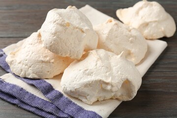 Delicious homemade meringue cookies on wooden table, closeup