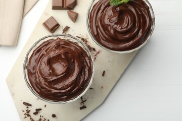 Delicious chocolate pudding on white table, flat lay
