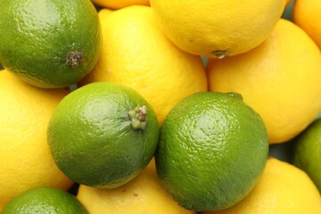 Fresh ripe lemons and limes as background, closeup