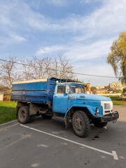 A blue truck is parked in a parking lot