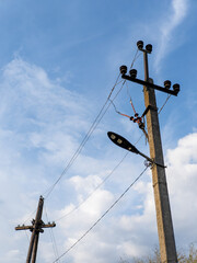 A telephone pole with a street light on top of it