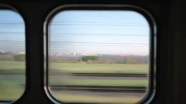 Blurred landscape view from train window representing travel, speed, and journey
