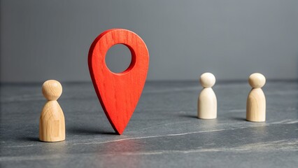 Navigating the Journey: A red wooden pin marker stands tall between two smaller wooden figures on a textured surface, symbolizing a path forward or a key decision point in life.