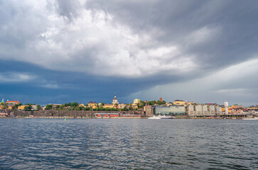 Naklejka premium Urban scene in Stockholm, Sweden with storm clouds in the background