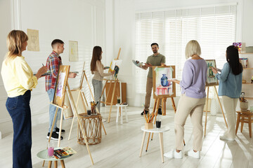 Artist and his students having painting class in studio