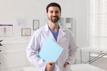 Fototapeta premium Portrait of professional doctor with clipboard in hospital