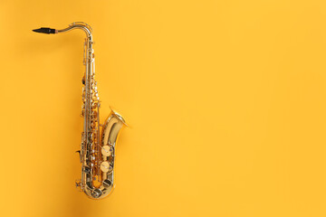 Golden saxophone on yellow background. Space for text