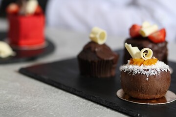 Tasty desserts on light grey table, closeup