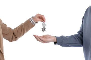 Real estate agent giving house key to new owner on white background, closeup
