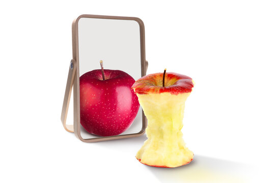 Almost eaten apple reflecting in mirror as whole, white background. Opposite, contrast, difference