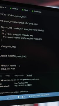 Vertical Video Young IT engineer typing code on computer and running script, programming language. African american technician in modern loft fixing errors within the software, implementing features