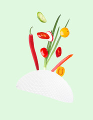 Rice paper and different ingredients falling on aquamarine color background