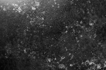 Dust on black textured surface, top view