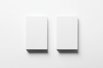 Two blank white business cards on a white background