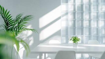 Sunlight streams through a window with a glass block panel, illuminating a white dining table with two chairs and plants