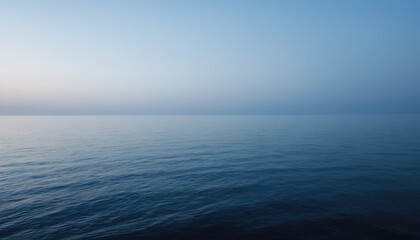 Obraz premium A serene seascape of blue waves meeting the calm horizon under a sunny sky dotted with soft white clouds