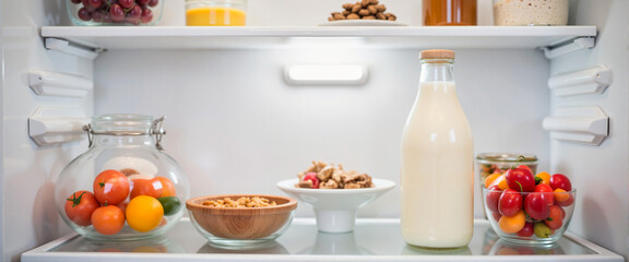 Fresh milk bottle labeled "No Antibiotics" in modern refrigerator, health