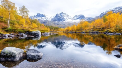 Fototapeta premium Autumnal alpine lake reflecting snow-capped peaks. Tranquil mountain scenery