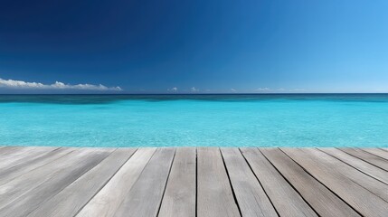 Fototapeta premium Tranquil ocean view from a wooden pier. Azure water meets a cloudless sky. Peaceful, summery scene