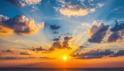 Obraz premium Dramatic sunset sky with vibrant colors and clouds. A breathtaking view of the sun setting behind a vast expanse of clouds, showcasing a beautiful array of warm hues