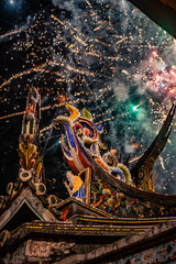 the intricate roof ridge of an ancient temple appears solemn and serene under the illumination of lights