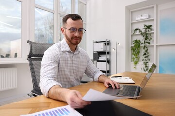 Handsome man working at desk in office