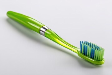 Close-up studio shot of a green toothbrush with blue and green bristles, promoting dental hygiene and oral health with a focus on cleanliness and fresh breath.