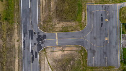 Vertical view of passenger terminal and stopping point for planes and helicopters on small airfield